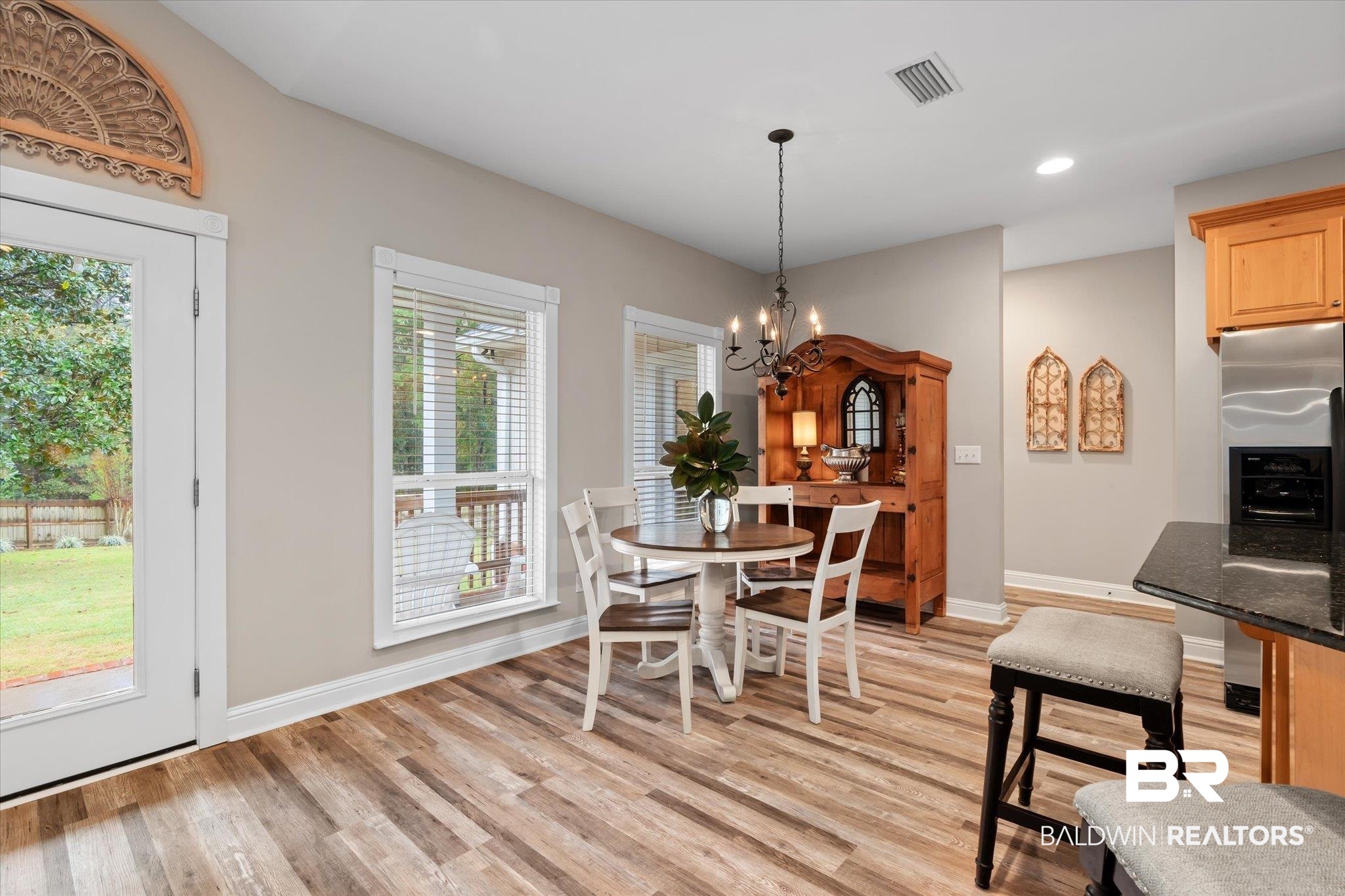 27994 Oakachoy Loop Daphne, AL 36526 - Photo 9 of 41 Dinette featuring an inviting chandelier, a healthy amount of sunlight, and light wood-type flooring