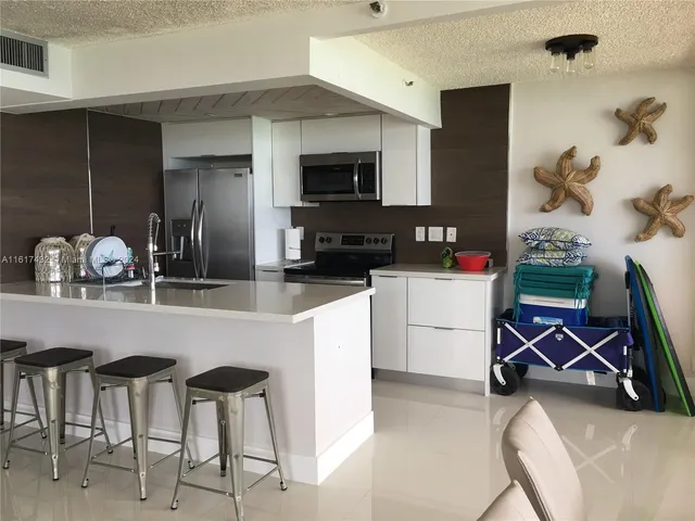 a kitchen with refrigerator and cabinets
