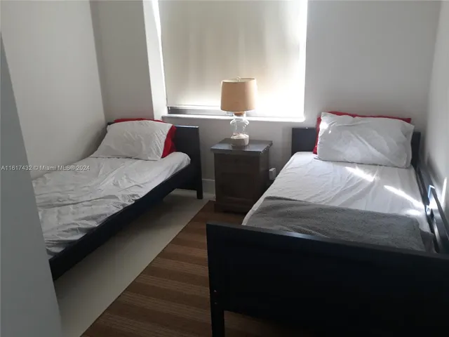 a bedroom with a bed and a night stand