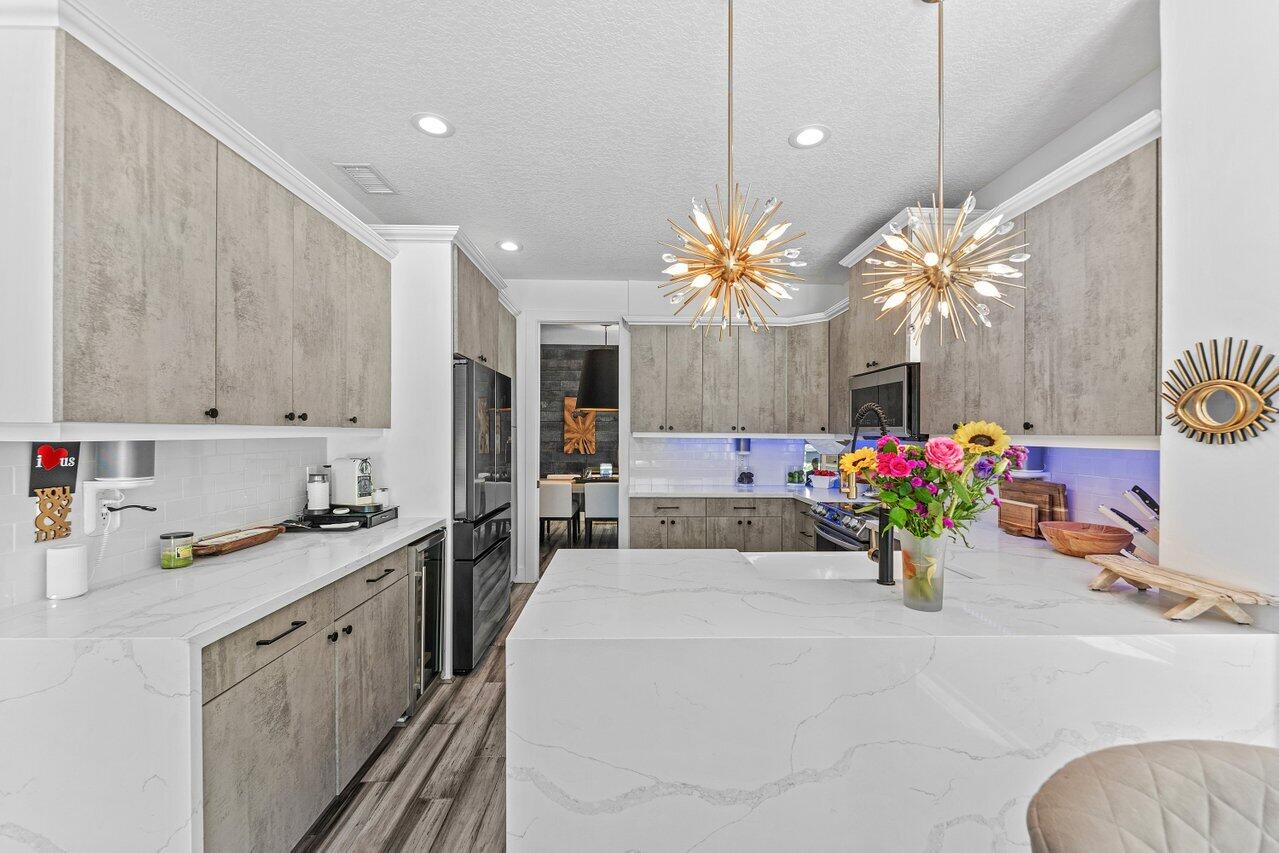 3395 Northwest 53rd Circle Boca Raton, FL 33496 - Photo 9 of 64 a kitchen with a sink and cabinets