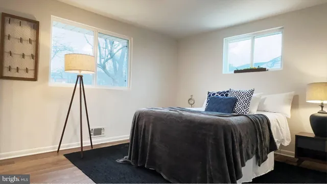 a bedroom with a bed and a lamp on table