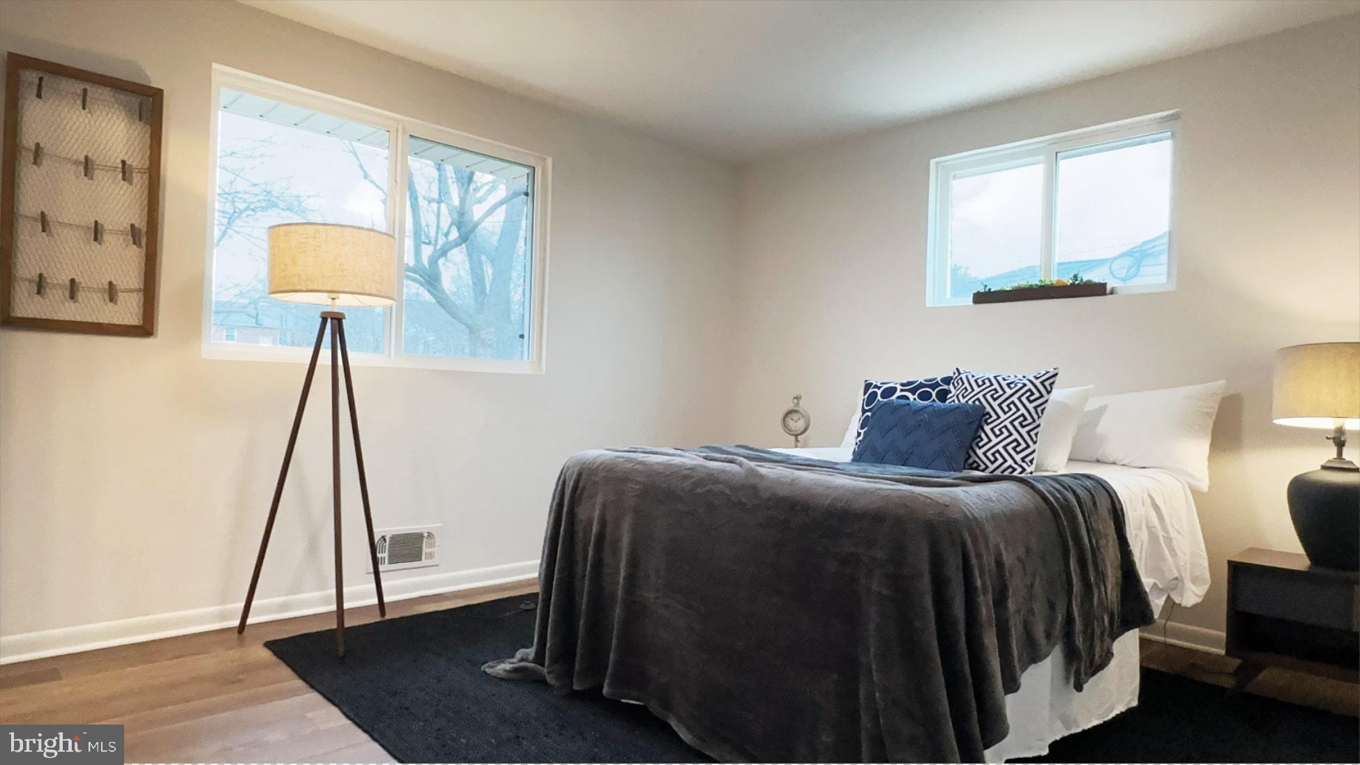 8802 Ashford Road Parkville, MD 21234 - Photo 12 of 39 a bedroom with a bed and a lamp on table