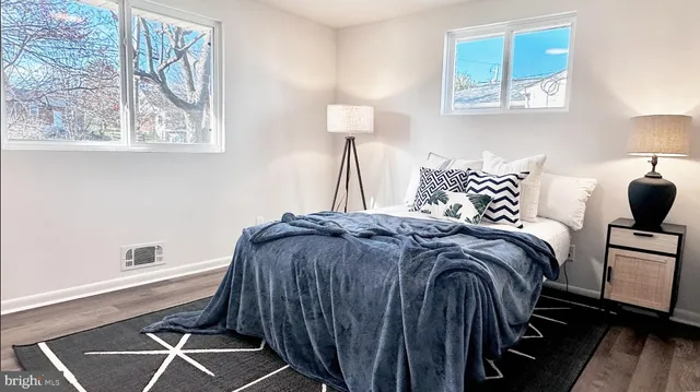 a bedroom with a bed and a lamp next to a window