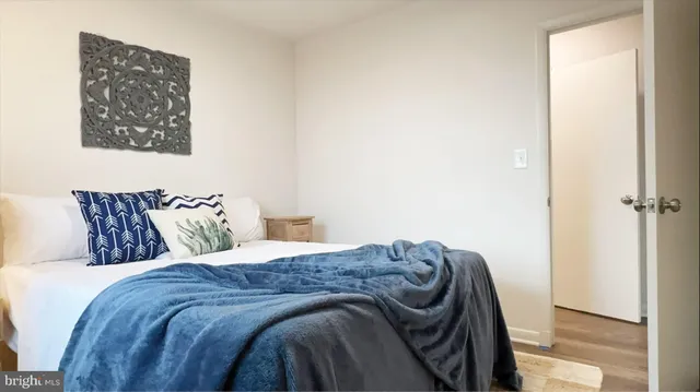 a bed sitting in a bedroom next to a window