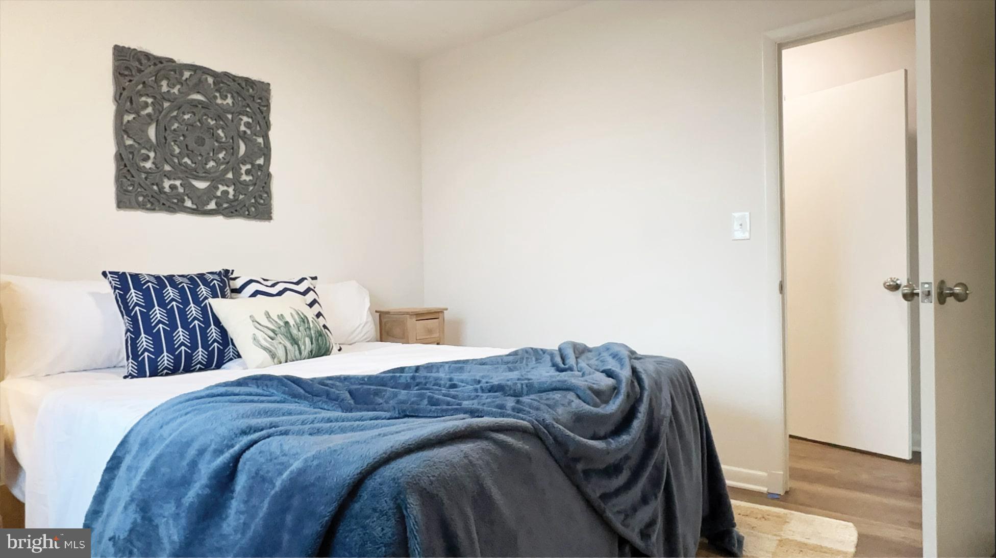 8802 Ashford Road Parkville, MD 21234 - Photo 18 of 39 a bed sitting in a bedroom next to a window