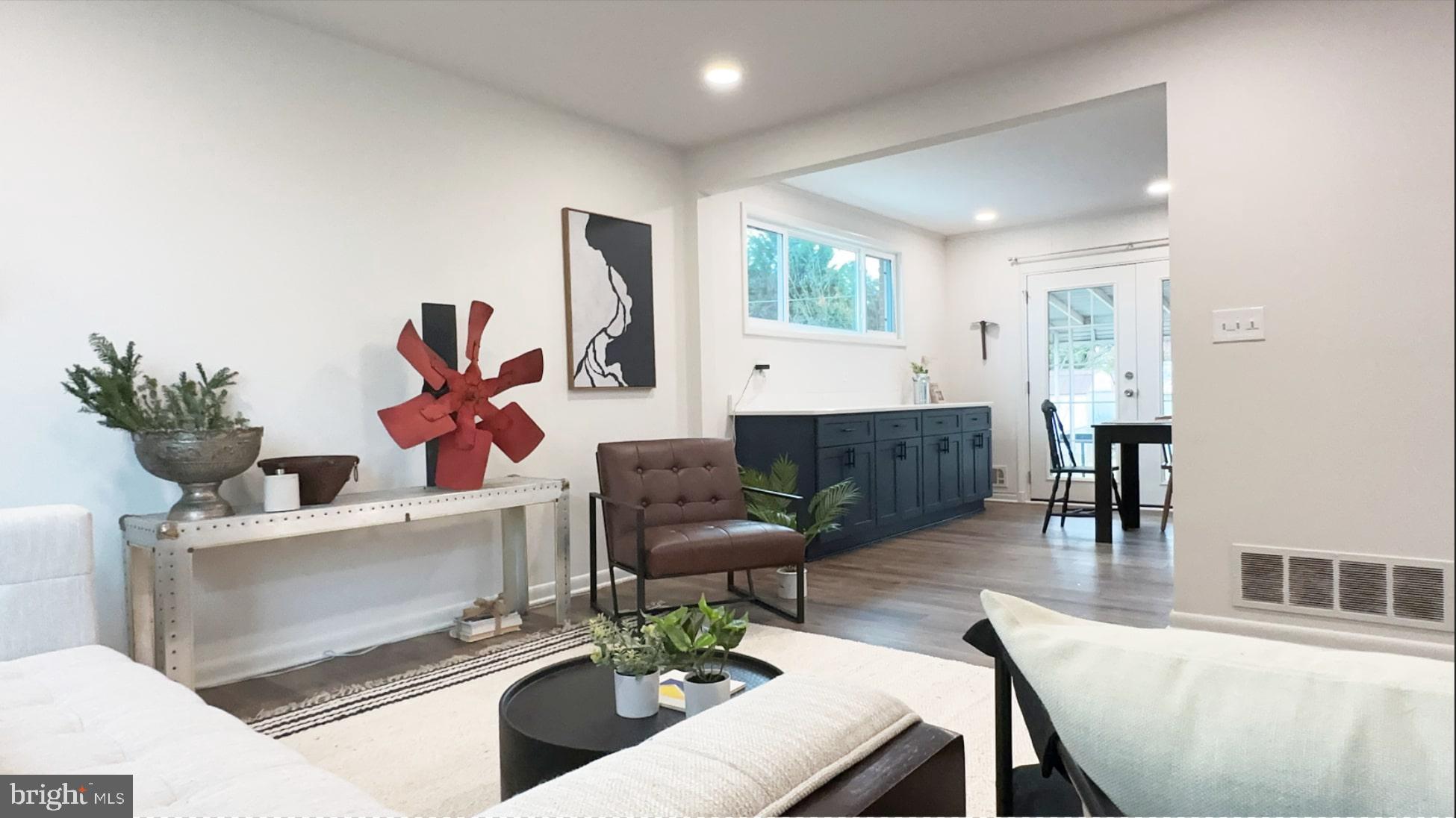 8802 Ashford Road Parkville, MD 21234 - Photo 2 of 39 a living room with furniture and a wooden floor
