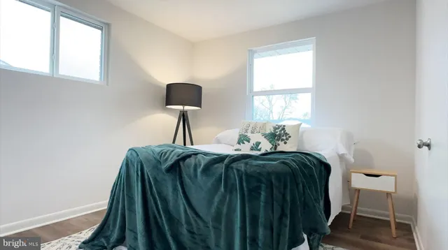 a bed sitting in a bedroom next to a window