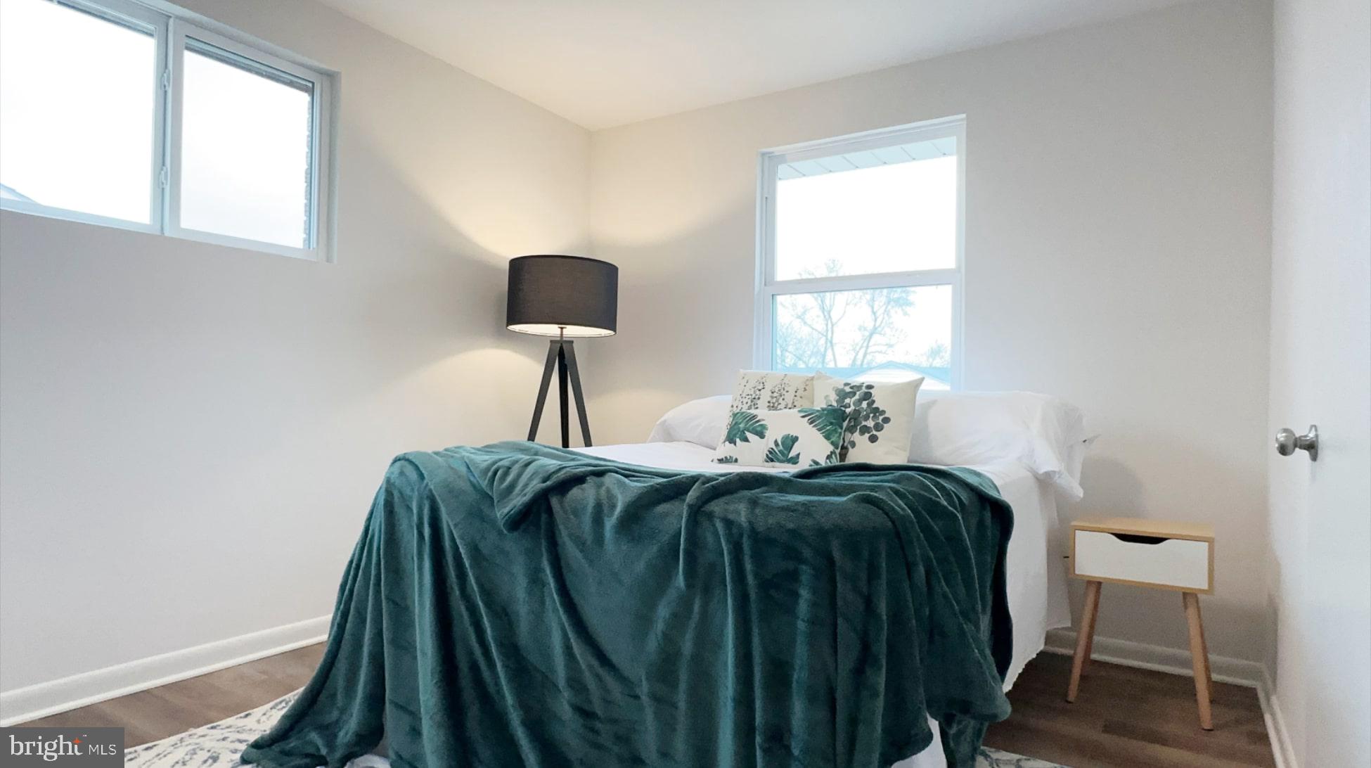 8802 Ashford Road Parkville, MD 21234 - Photo 21 of 39 a bed sitting in a bedroom next to a window