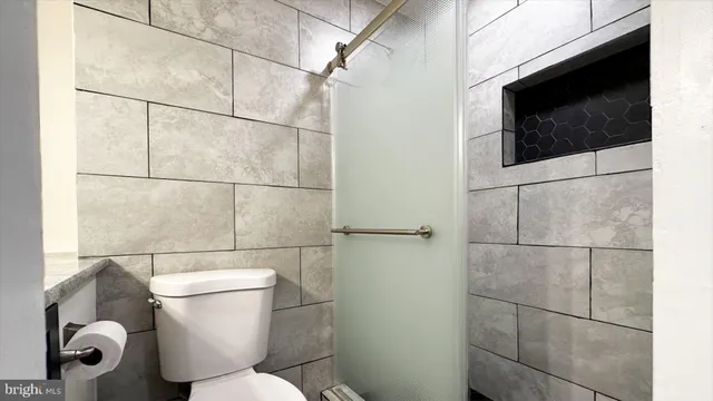 a bathroom with a toilet and a shower
