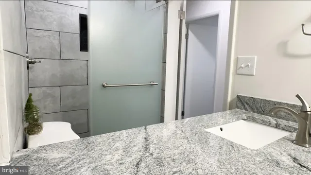 a bathroom with a sink and shower