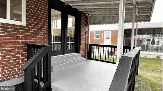 a view of a balcony with furniture and floor to ceiling window