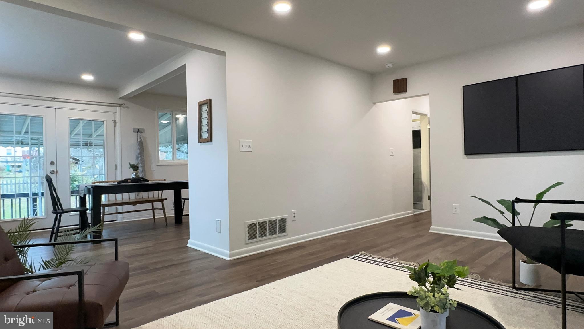 8802 Ashford Road Parkville, MD 21234 - Photo 29 of 39 a living room with furniture and a wooden floor