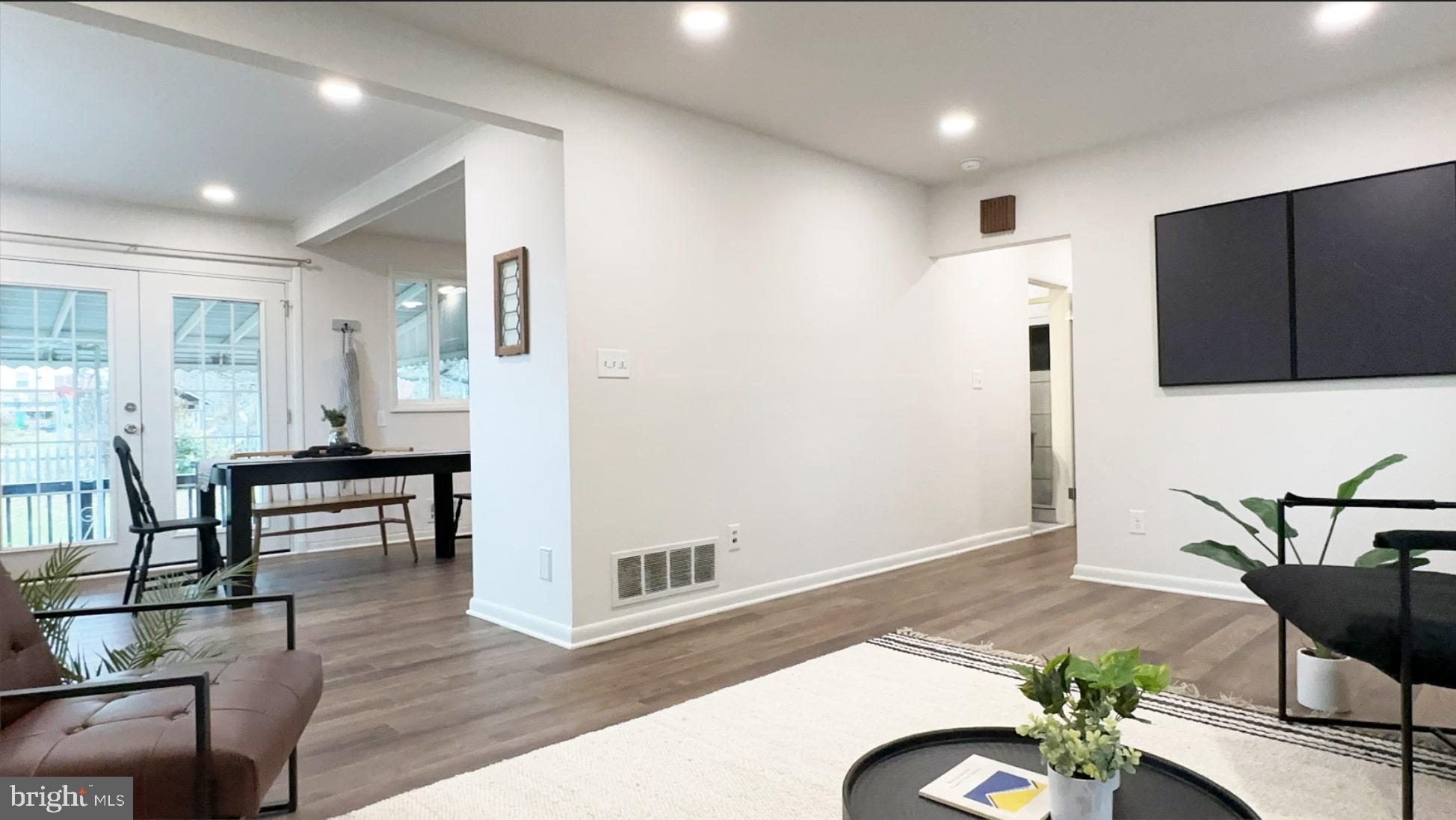 8802 Ashford Road Parkville, MD 21234 - Photo 6 of 39 a living room with furniture and a wooden floor