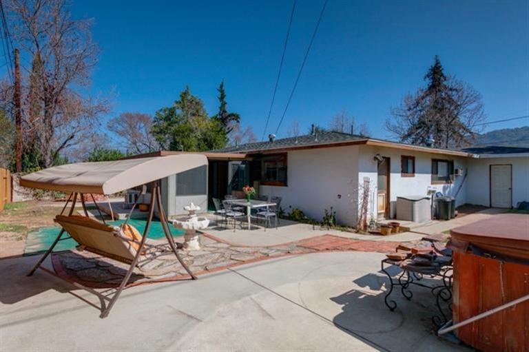 985 Spring Street Oak View, CA 93022 - Photo 13 of 15 a view of a patio with a table and chairs under an umbrella