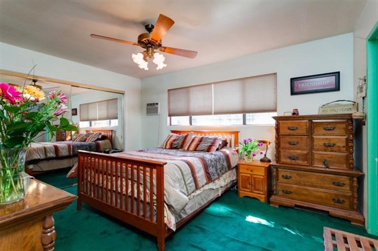 985 Spring Street Oak View, CA 93022 - Photo 10 of 15 a bed room with a bed and a chandelier