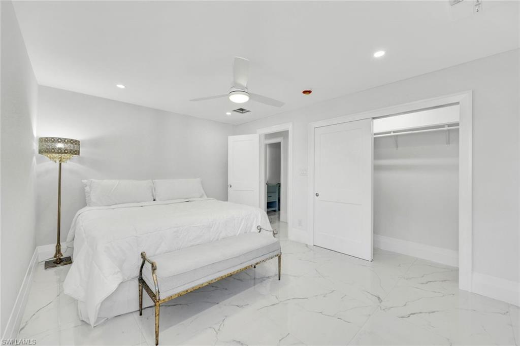 20 Kings Road, Unit A18 Naples, FL 34112 - Photo 11 of 19 a large white bed in a white room