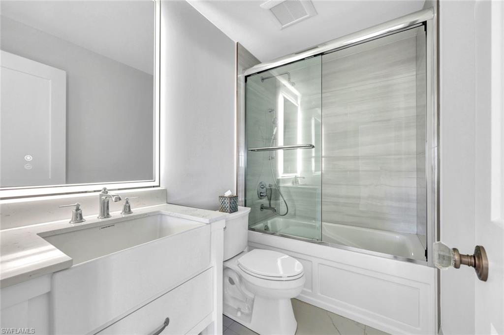 20 Kings Road, Unit A18 Naples, FL 34112 - Photo 13 of 19 a bathroom with a sink toilet and shower