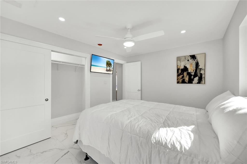 20 Kings Road, Unit A18 Naples, FL 34112 - Photo 15 of 19 a bedroom with a bed and a painting on the wall