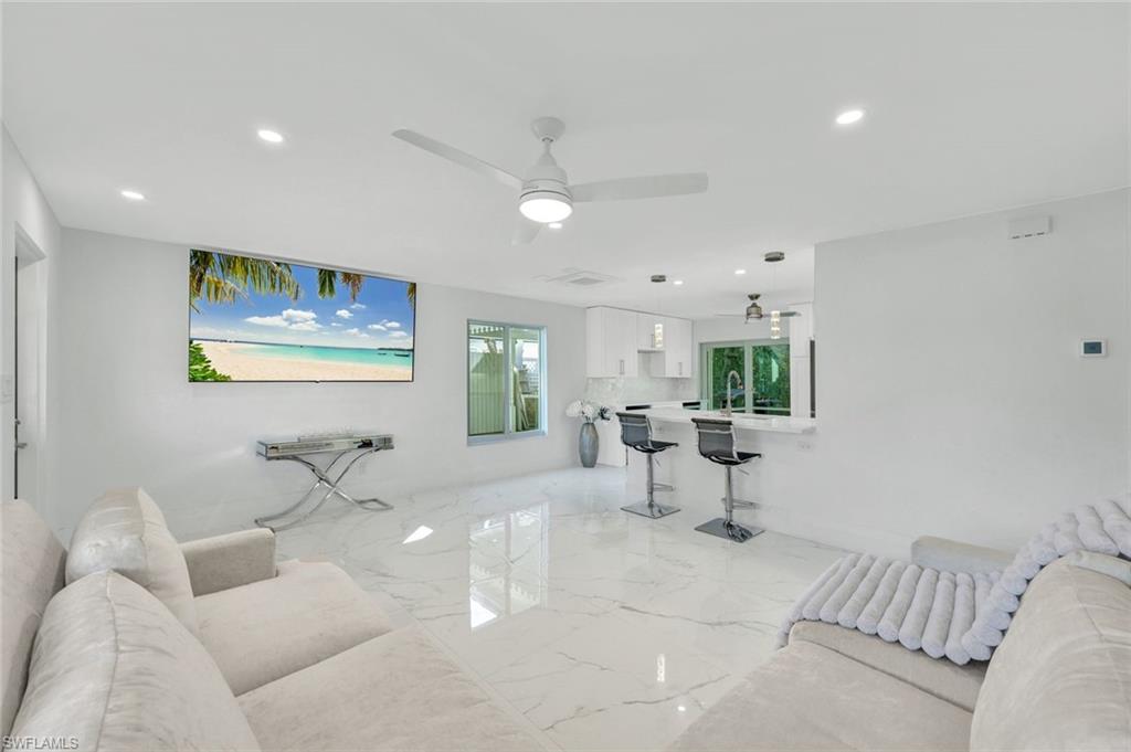 20 Kings Road, Unit A18 Naples, FL 34112 - Photo 3 of 19 a living room with furniture and window