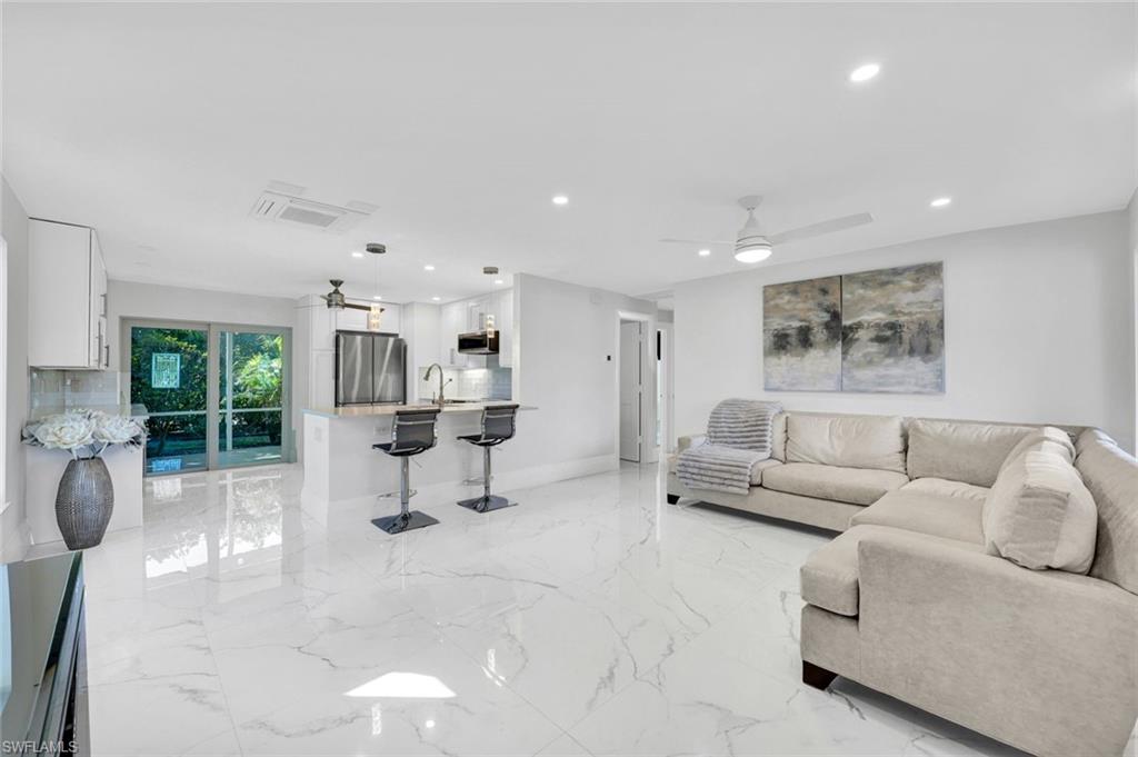 20 Kings Road, Unit A18 Naples, FL 34112 - Photo 5 of 19 a living room with furniture and white walls