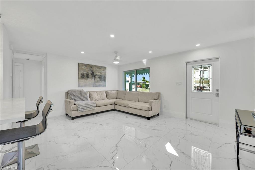 20 Kings Road, Unit A18 Naples, FL 34112 - Photo 6 of 19 a living room with furniture and a couch