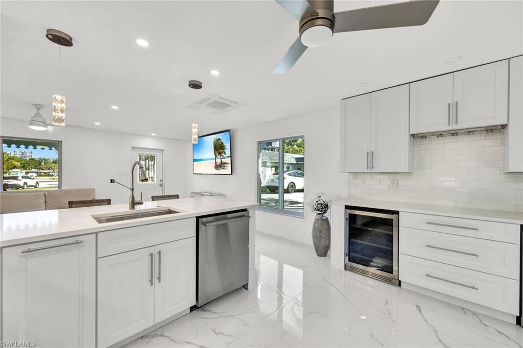 20 Kings Road, Unit A18 Naples, FL 34112 - Photo 9 of 19 a kitchen with a sink and cabinets