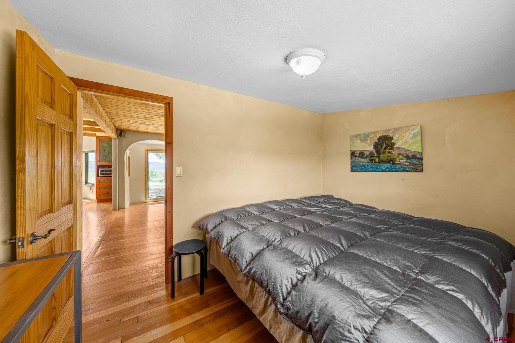 27778 Rd P Dolores, CO 81323 - Photo 18 of 45 a bedroom with a bed and wooden floor