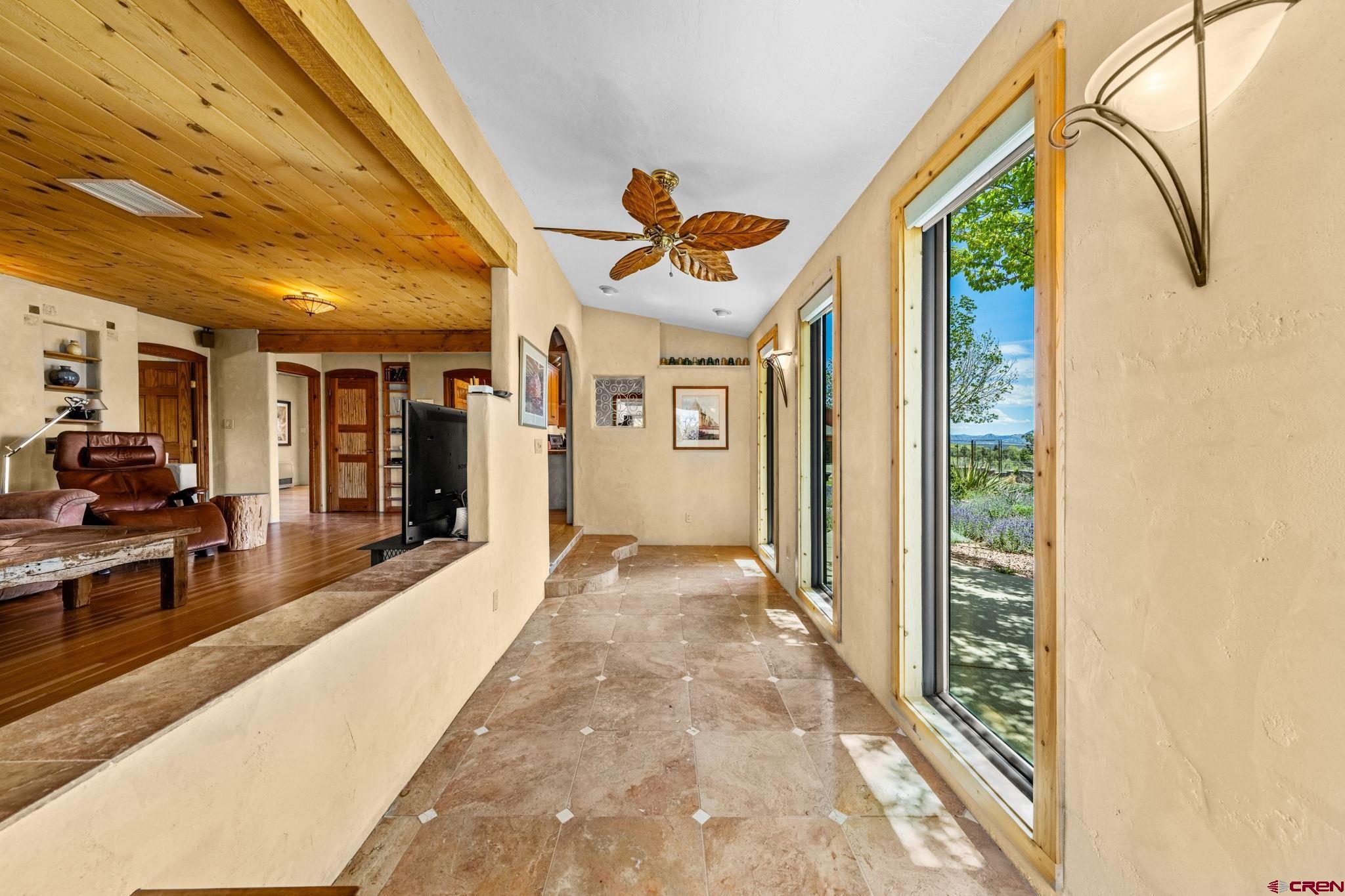 27778 Rd P Dolores, CO 81323 - Photo 23 of 45 a view of a hallway with a dining table & chairs