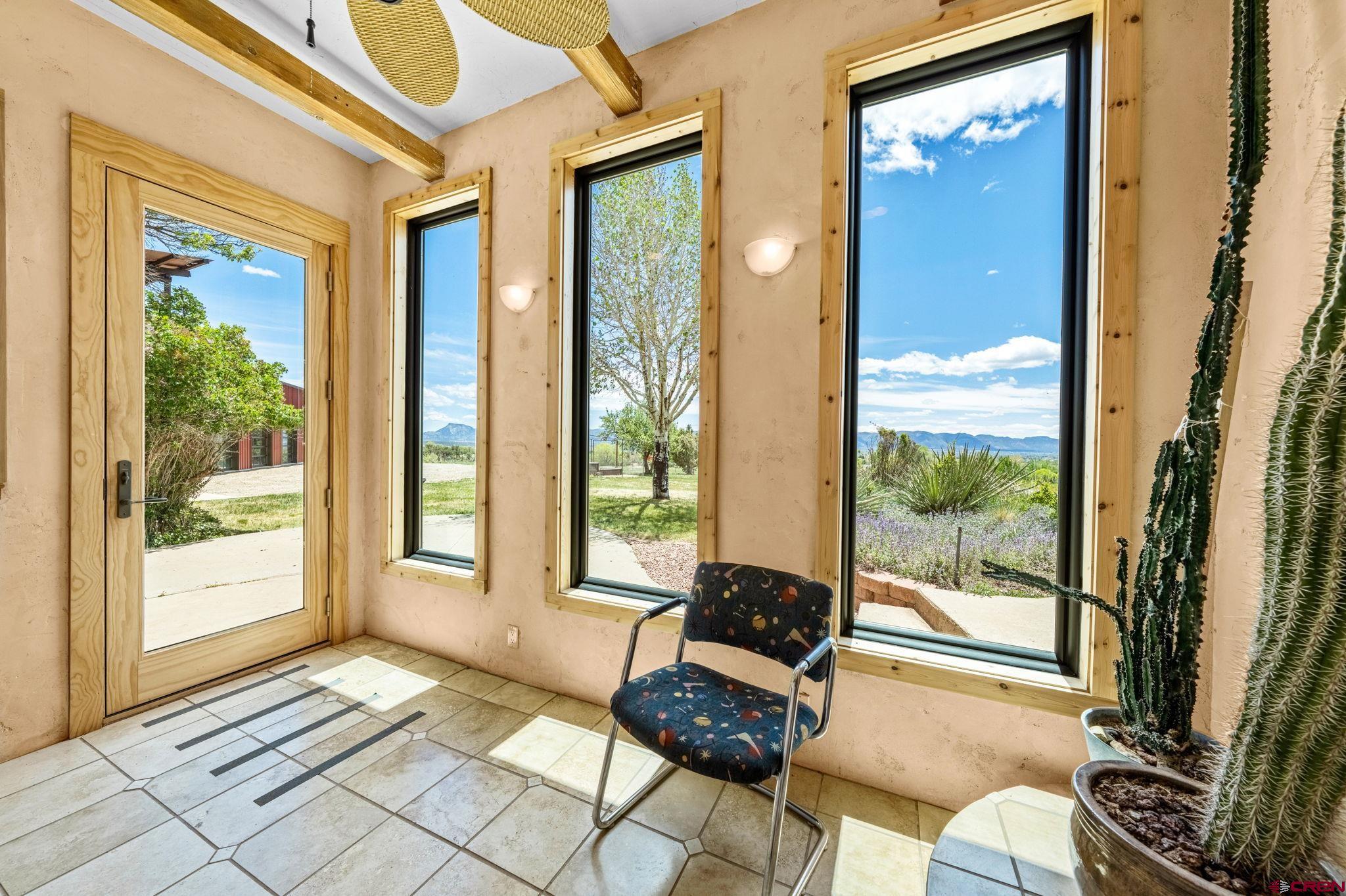 27778 Rd P Dolores, CO 81323 - Photo 32 of 45 a living room with furniture and a floor to ceiling window