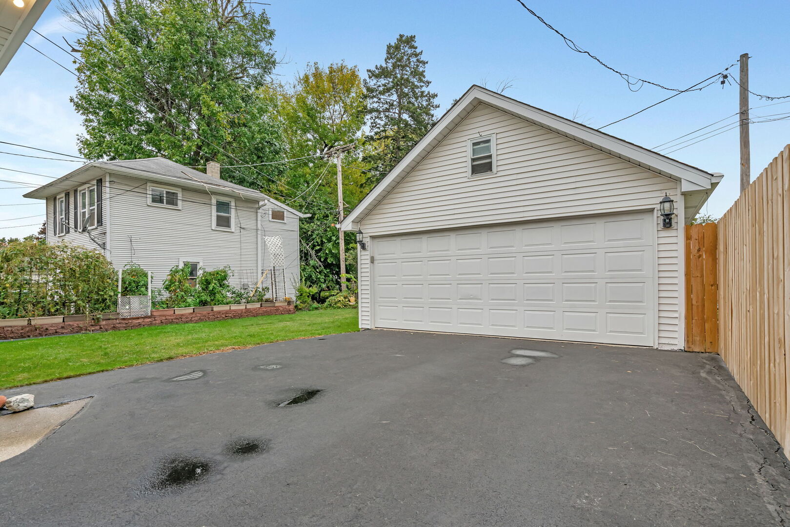 1105 Taylor Street Joliet, IL 60435 - Photo 21 of 24 a front view of a house with a yard and garage