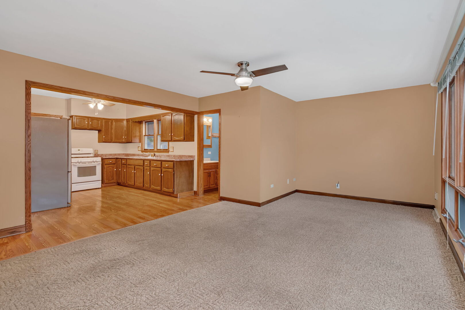 1105 Taylor Street Joliet, IL 60435 - Photo 5 of 24 a view of a kitchen with a stove cabinets a ceiling fan and wooden floor