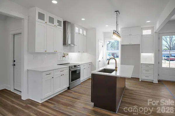 a kitchen with a sink window and cabinets