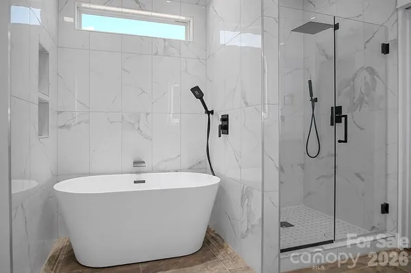 a bathroom with a bathtub and shower