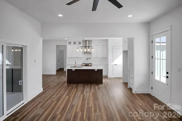 a large room with wooden floor and windows