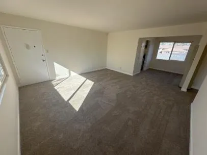 a view of wooden floor and windows in a room