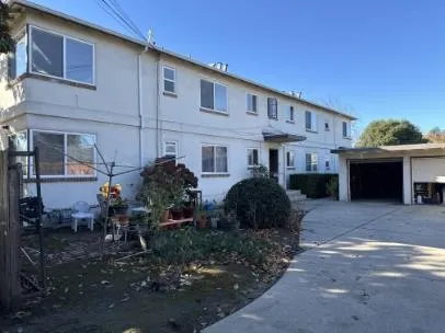 a front view of a house with table and chairs
