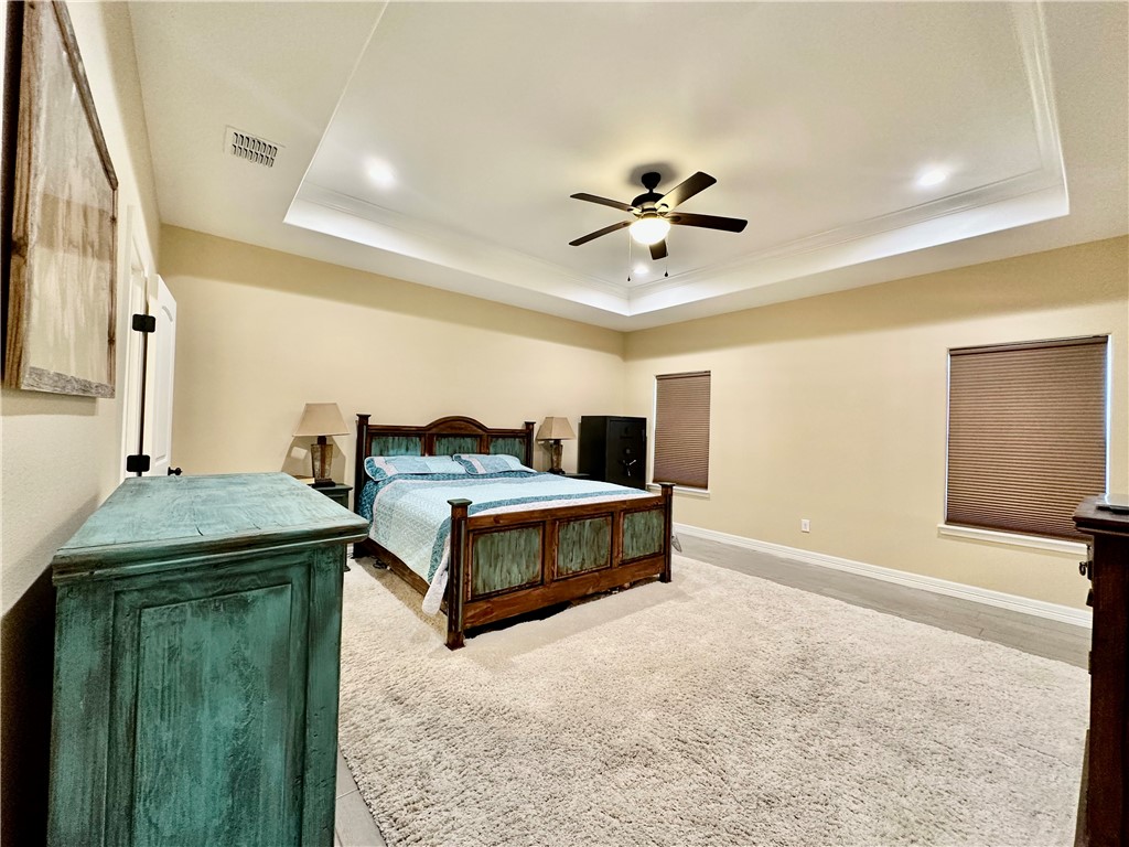 5434 Neela Corpus Christi, TX 78413 - Photo 17 of 31 a bedroom with a bed and a chandelier