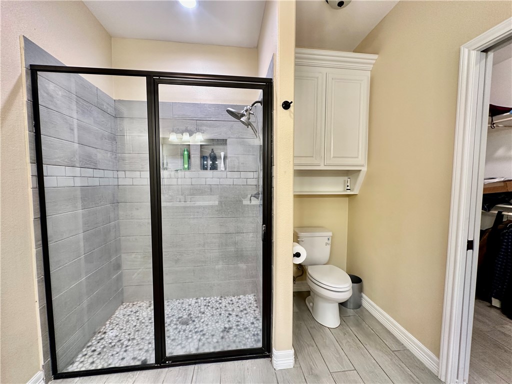 5434 Neela Corpus Christi, TX 78413 - Photo 21 of 31 a bathroom with a granite countertop shower and a toilet