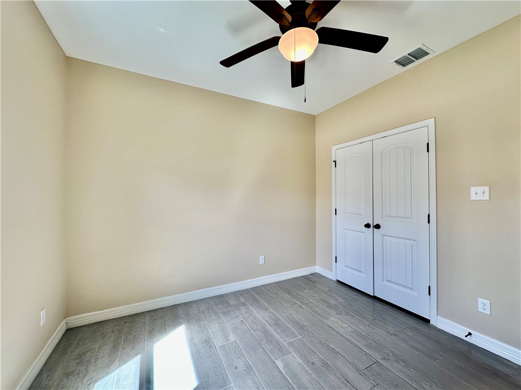 5434 Neela Corpus Christi, TX 78413 - Photo 22 of 31 an empty room with a window and a ceiling fan