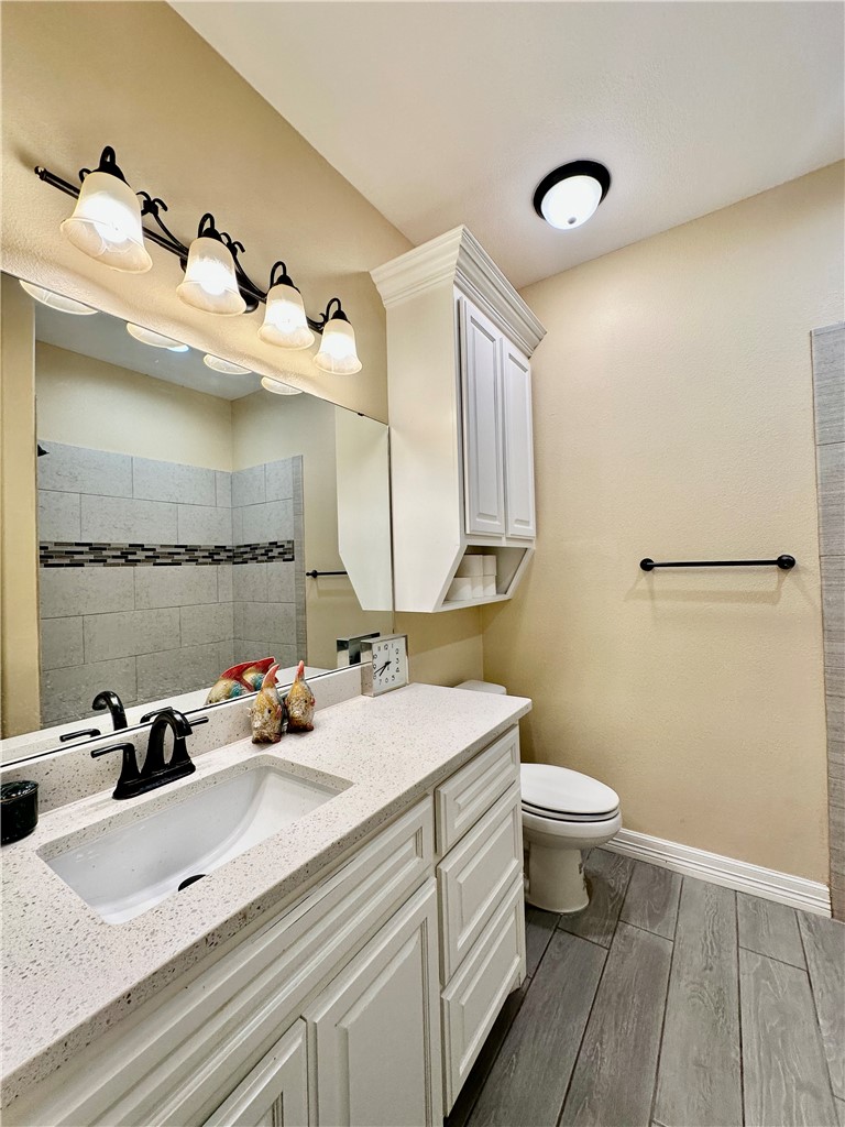 5434 Neela Corpus Christi, TX 78413 - Photo 25 of 31 a bathroom with a sink mirror and toilet