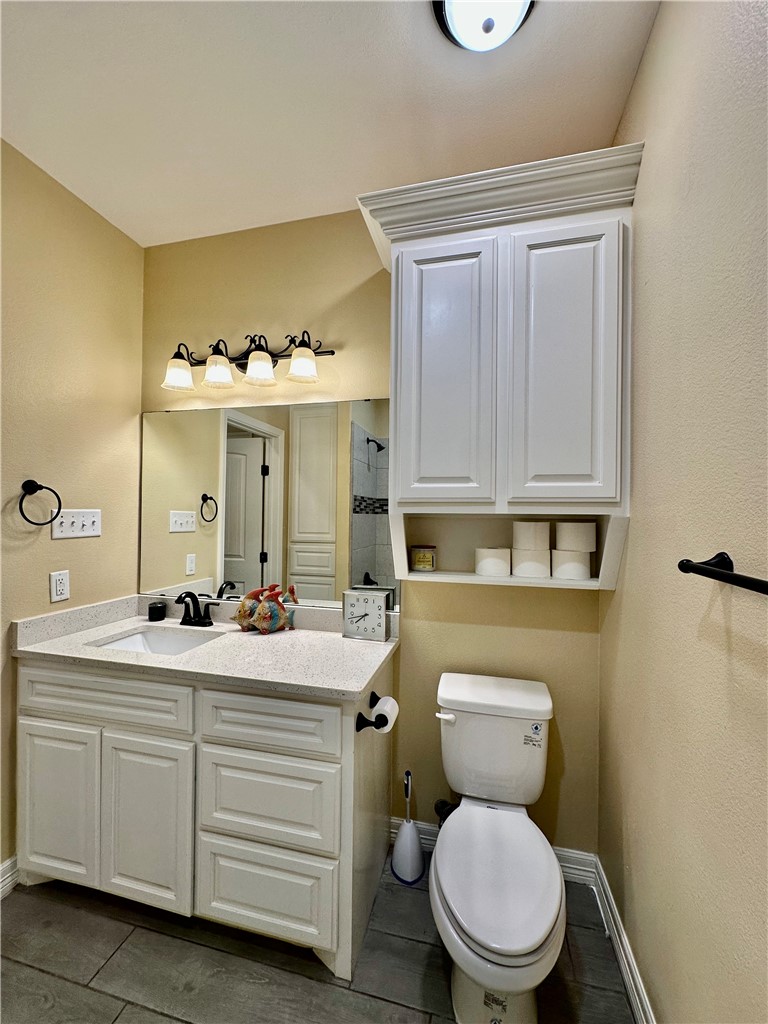 5434 Neela Corpus Christi, TX 78413 - Photo 27 of 31 a bathroom with a toilet sink and mirror