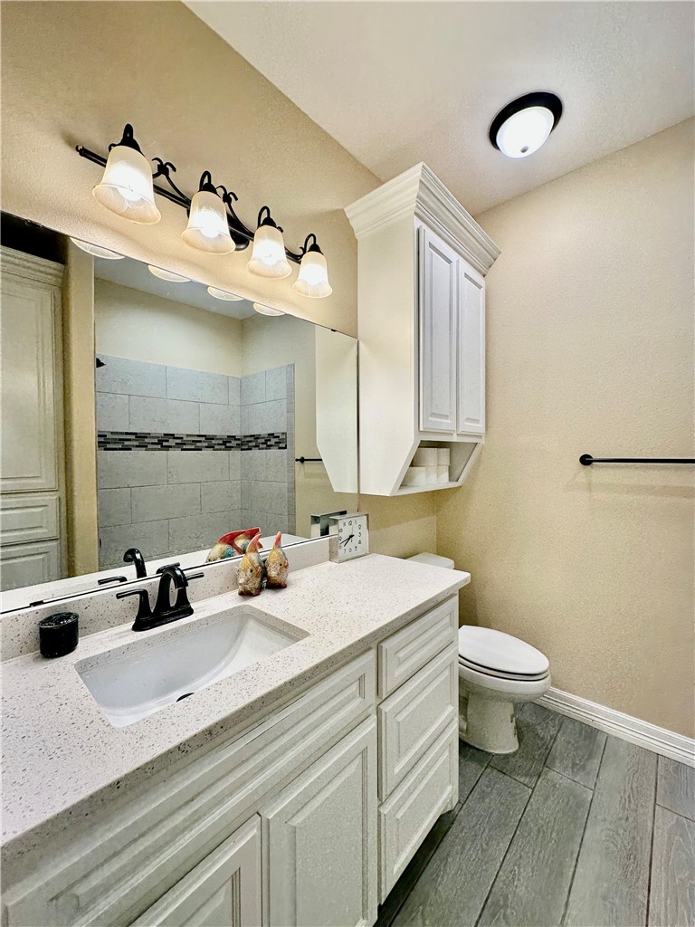 5434 Neela Corpus Christi, TX 78413 - Photo 28 of 31 a bathroom with a double vanity sink mirror and toilet