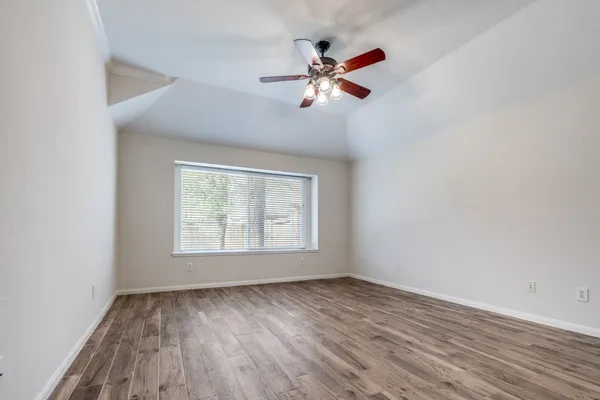 wooden floor in an empty room with a window