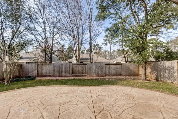 a view of backyard of house with trees