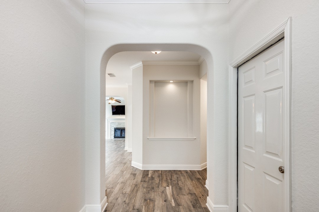 130 South Veranda Ridge Drive Spring, TX 77382 - Photo 3 of 23 a view of a hallway with wooden floor and a bathroom
