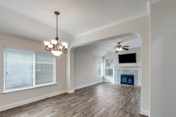 a view of a livingroom with a furniture wooden floor fireplace and a window