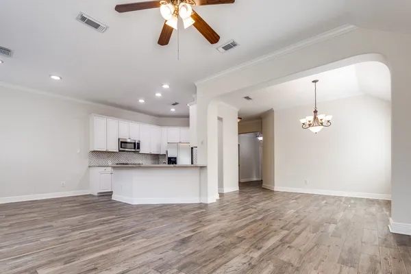 a view of a kitchen and a chandelier fan