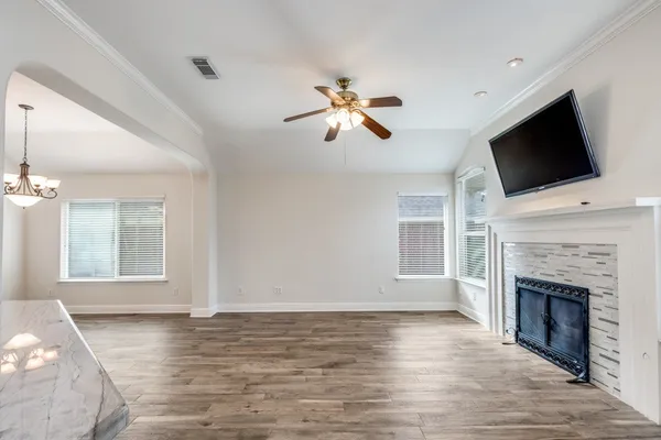 a view of a livingroom with a fireplace a window and a fireplace