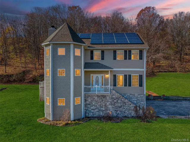 a front view of a house with a garden