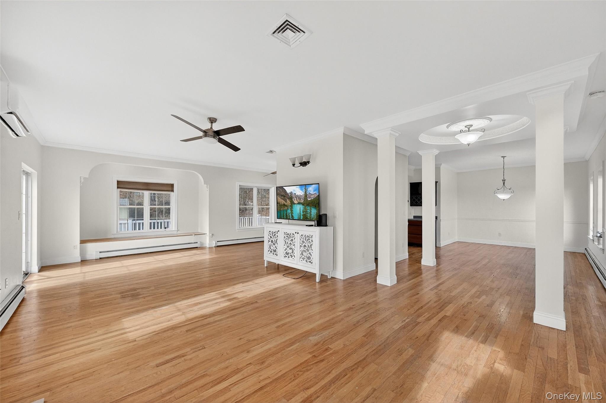 237 Lattintown Road Marlboro, NY 12542 - Photo 11 of 34 a view of a livingroom with wooden floor and a ceiling fan
